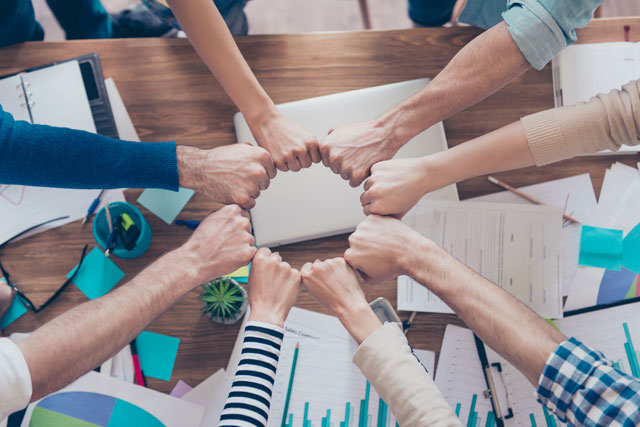 Team demonstrating successful corporate turnaround with human resources from Flex HR