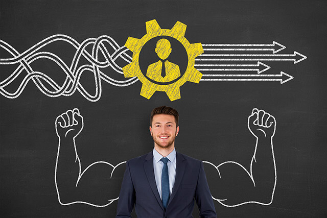 HR training development with man standing against chalkboard with chalk drawings behind him
