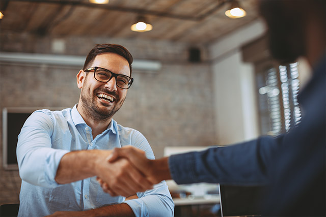 Man getting hired after recruiting, close up of handshake in the office