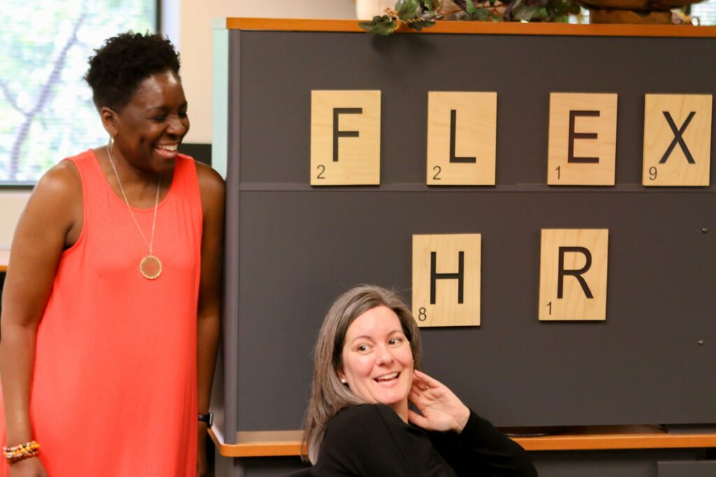 HR employees sharing new hire compliance paperwork in a modern-style office
